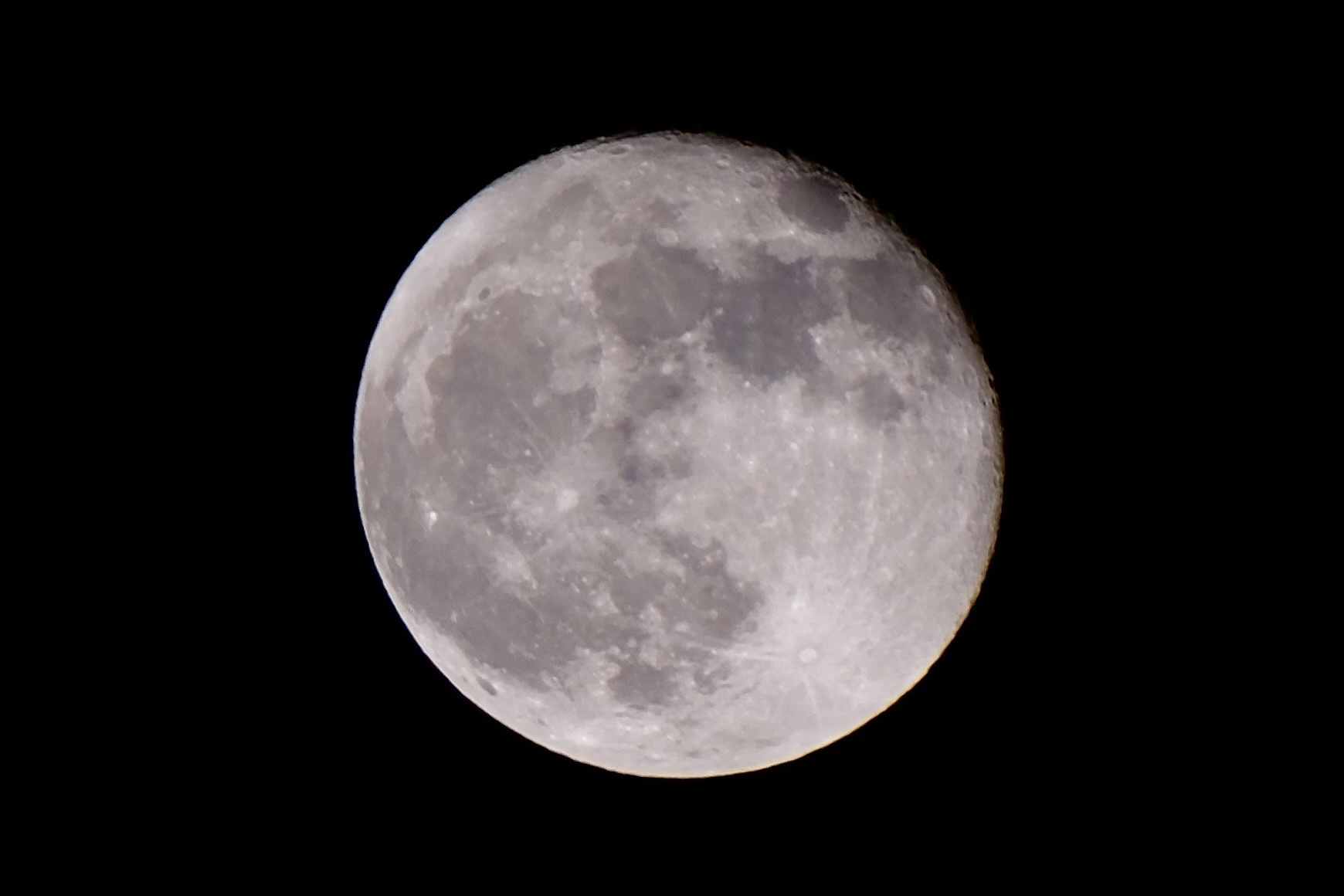 A clear, detailed photograph of the full moon against a black night sky. The lunar surface shows visible craters and dark maria, highlighting the moon's texture and features.